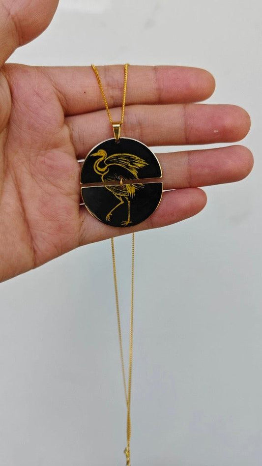 Graceful crane necklace, bronze pendant, handmade necklace with natural Chinese lacquer; hand holding near