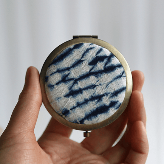 handmade_tie-dye_pocket_mirror_electric_pattern_hand_holding